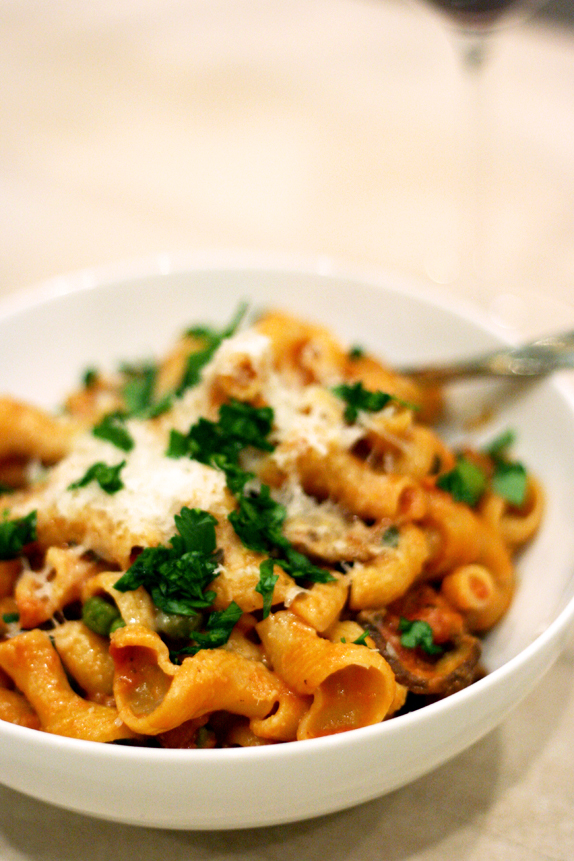 pasta with porcini tomato cream sauce, peas, and pancetta
